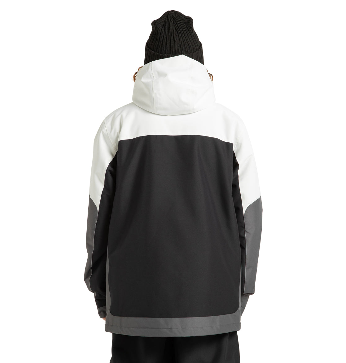 A person is shown from the back wearing the DC Shoes Men’s Defiant Insulated Jacket, crafted from recycled polyester. This black and white jacket features a white hood and upper section with dark grey and black lower sections, paired with a black knit beanie—an ideal choice for any winter adventure.