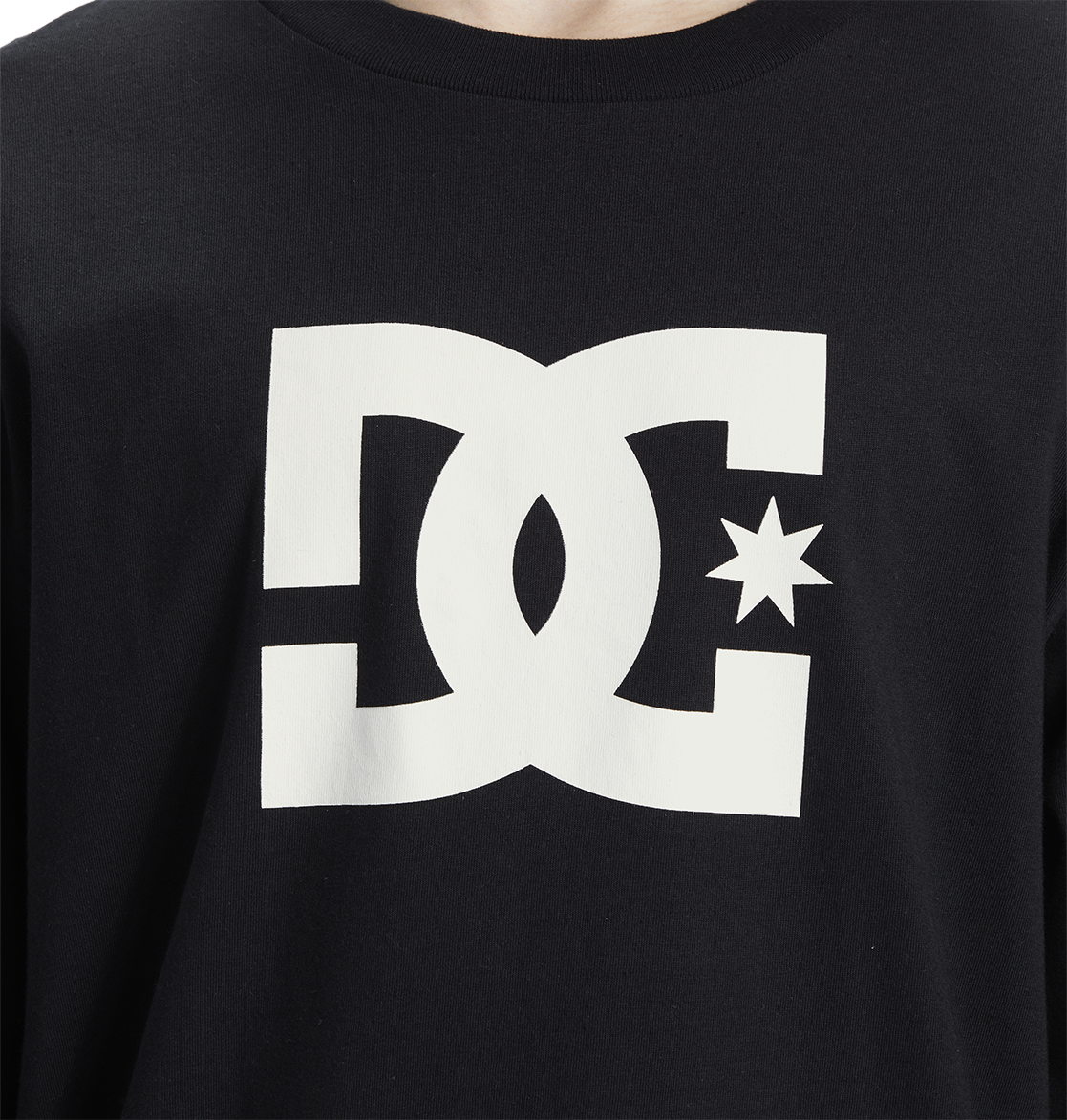 Close-up of the Men's DC Star Tee by DC Shoes, a black graphic shirt with a large white logo featuring stylized D and C letters, star detail, and bold front artwork—ideal for skate sessions.