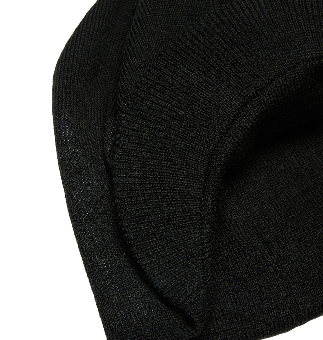 A close-up of the DC Shoes Big Star Visor, a black knitted beanie hat with a folded edge and textured ribbed fabric, showcasing classic knit construction and subtle DC Shoes branding.