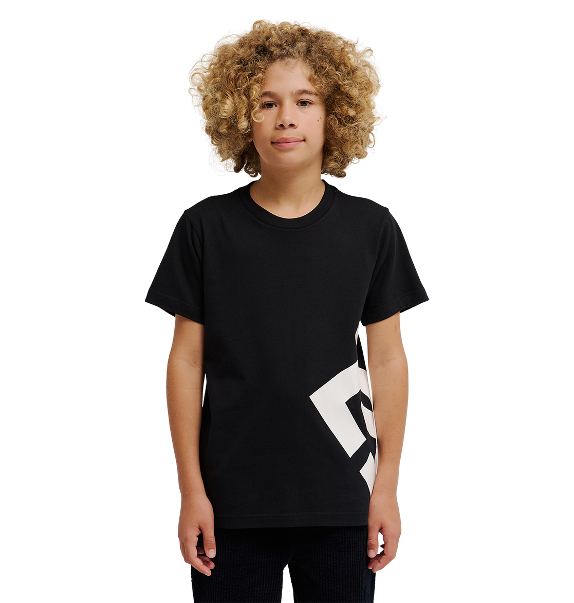 A young person with curly blonde hair wears the DC Shoes DC Lanai Tee Youth, a black relaxed-fit skate shirt with a bold white graphic on one side, standing against a plain white background.