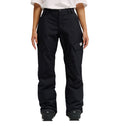 A person is shown from the waist down, wearing DC Shoes’ Nonchalant Pant in black with a white shirt. The pants are loose-fitting and insulated, featuring flap pockets and a small white DC Shoes logo on the left thigh for added style and dependable snow performance. Their arms rest relaxed at their sides.