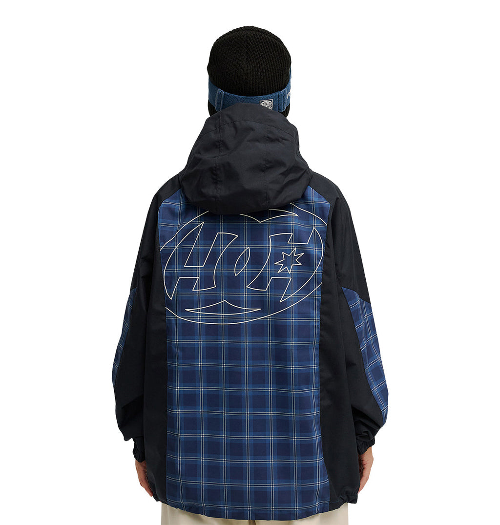 A person wears the DC Shoes Trackstar Jacket 10K—a dark hooded jacket with a blue plaid pattern and a large outlined logo on the back—offering breathable protection and excellent snow performance, standing against a white background.