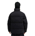 Wearing the DC Shoes Trackstar Puffer 10K jacket and a black beanie, a person stands with their back to the camera against a plain white background, highlighting both style and snow-ready performance.