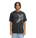 A young man with braided hair wears the Reebok Strike Twice Hss—a loose black t-shirt with a bold, abstract white graphic and text—standing facing forward, arms relaxed at his sides against a plain white background.