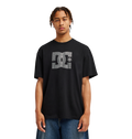 A person stands facing forward against a plain white background, wearing the Men’s DC Strass Star Tee by DC Shoes—a relaxed fit black graphic skate tee featuring a rhinestone DC star—paired with blue jeans.