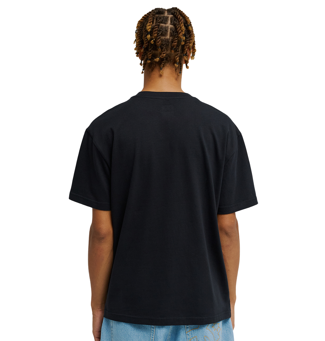 A person with short, twisted braids is shown from the back, wearing the DC Shoes Men's DC Side Flame Tee and light blue jeans against a plain white background, capturing the laid-back style synonymous with skate sessions.