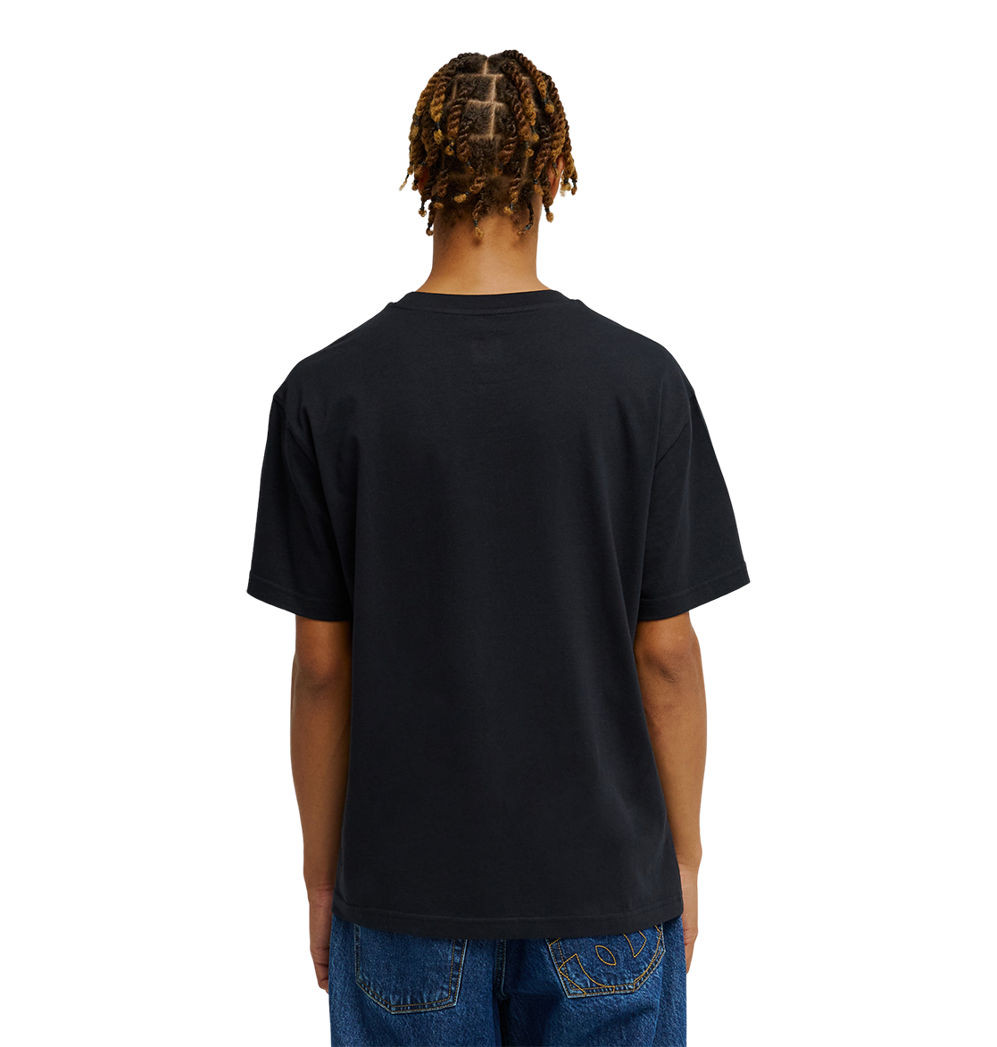 A person with braided hair is shown from the back against a plain white background, wearing blue jeans and the Men's DC Heritage Font Tee by DC Shoes in a black relaxed fit graphic skate style.