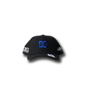 The KB 43 Snapback by DC Shoes is a black baseball cap from the Ken’s Rally Teamworks Collection, showcasing a bold blue logo embroidered on the front and striking white BLOCK print graphic details on the visor and sides, presented against a white background.